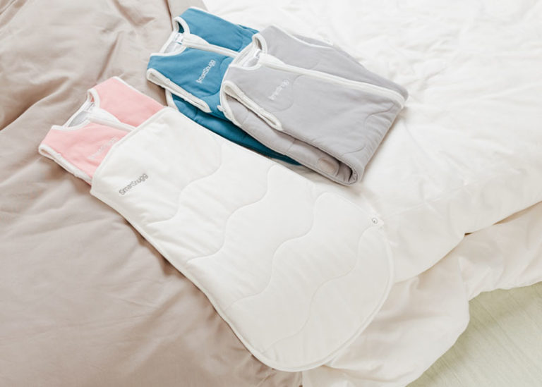 SmartSnugg-Sleep-Suit-Range-on-Bed